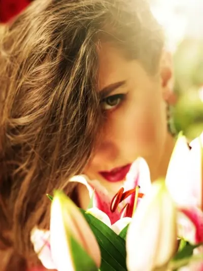 Leah-Lindsay-Face-Close-Up-Behind-Flowers
